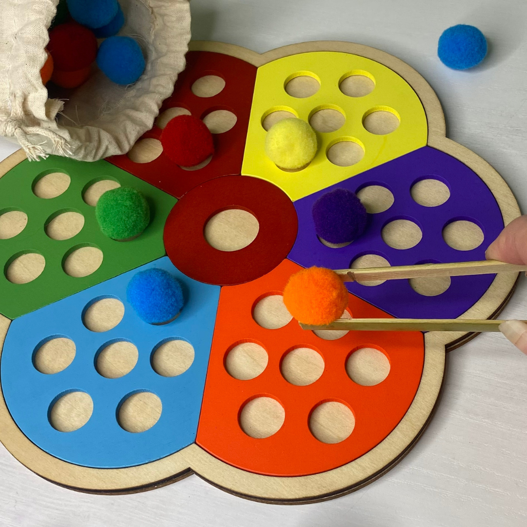 Practice coordination and exercise your child's pincer grasp as they match up the colorful pom poms with their coordinating space on wooden, flower puzzle!