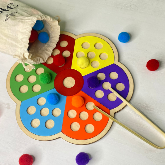 practice pre-writing skills and exercise your child's fine motor skills with this fun, pom pom/wooden puzzle. Comes with colorful pom poms and tongs!