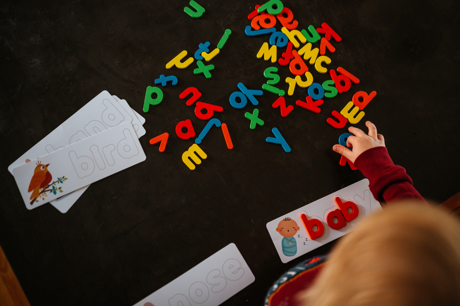 develop fine motor skills when matching up our wooden letters to the word cards